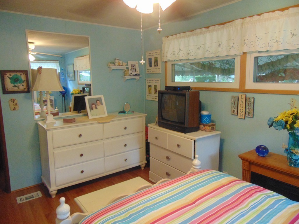 3132 Cranberry Highway, Unit 56 Wareham, MA 02538 - Photo 20 of 20 a bed room with a bed and a dresser