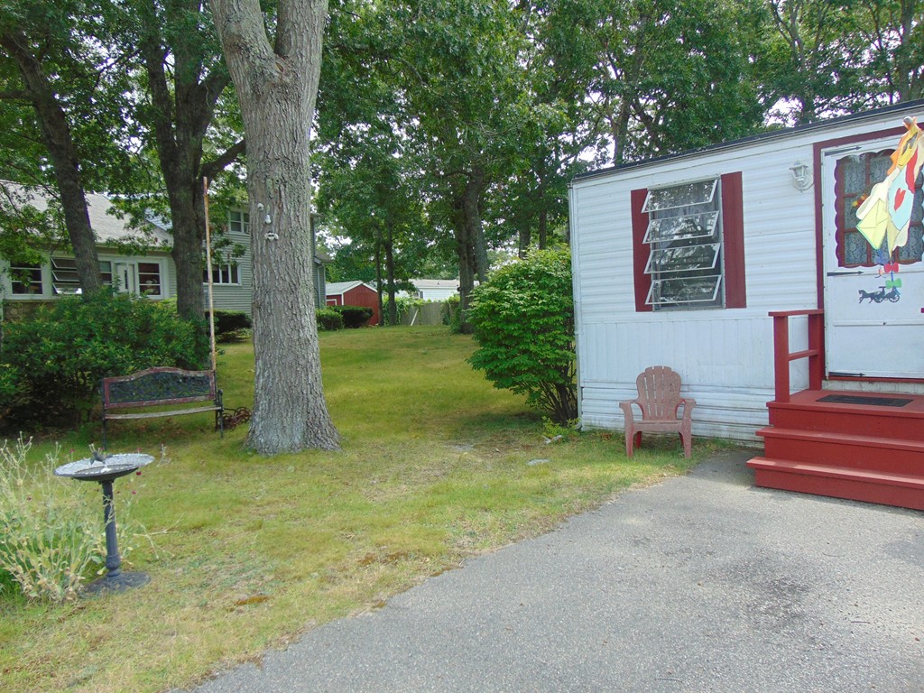 3132 Cranberry Highway, Unit 56 Wareham, MA 02538 - Photo 3 of 20 a front view of a house with garden