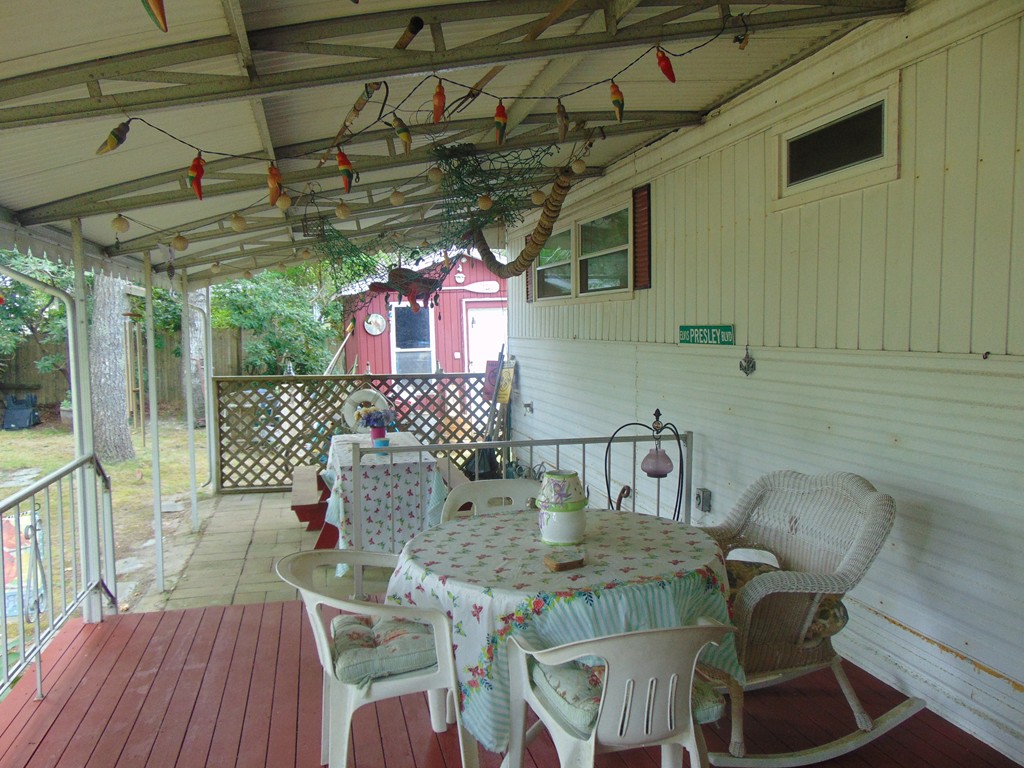 3132 Cranberry Highway, Unit 56 Wareham, MA 02538 - Photo 4 of 20 a view of a chairs and table in patio
