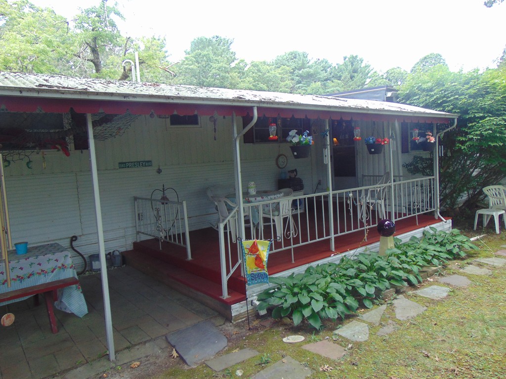 3132 Cranberry Highway, Unit 56 Wareham, MA 02538 - Photo 6 of 20 a view of a deck with a backyard