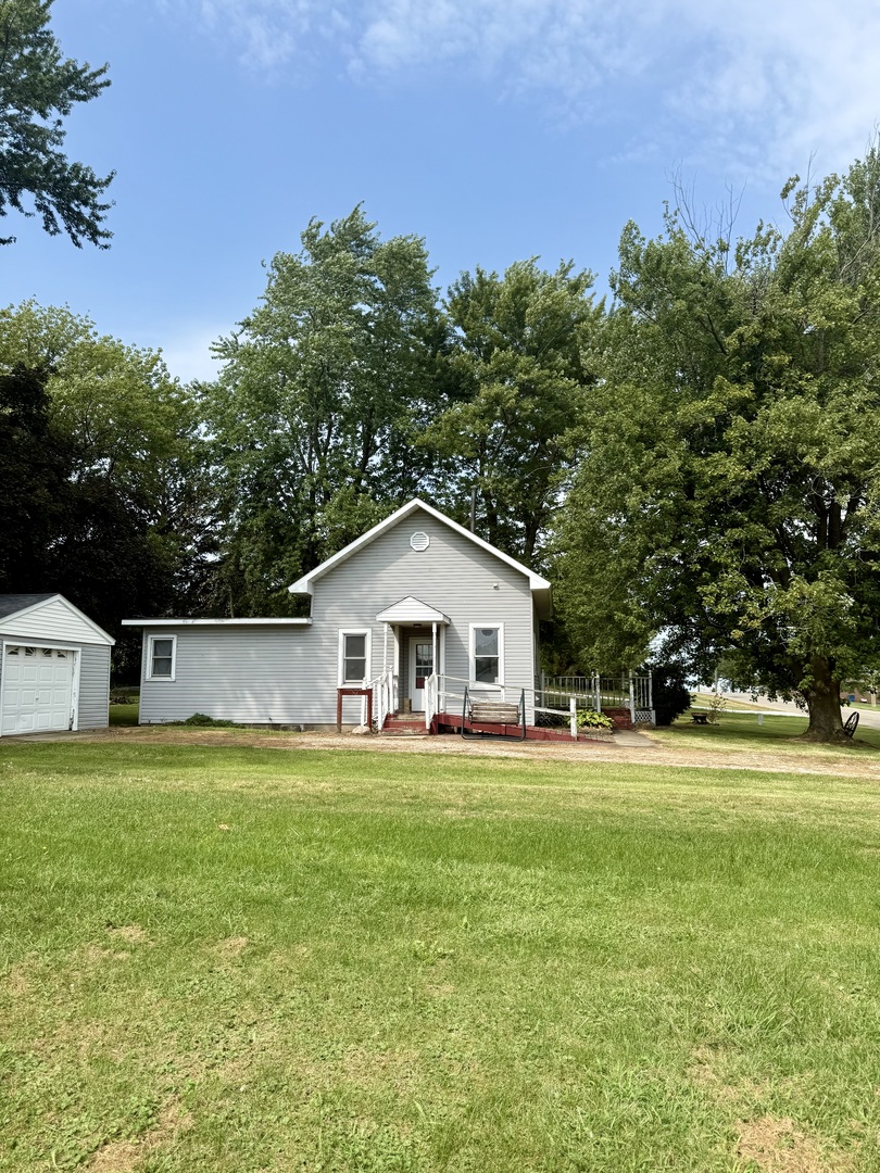 303 West Plumb Street Ransom, IL 60470 - Photo 1 of 12 a white house with a big yard and large trees