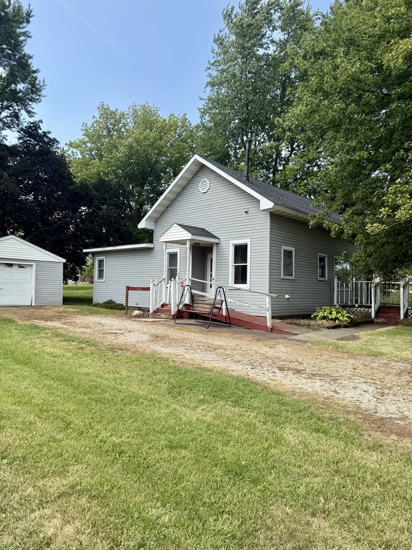303 West Plumb Street Ransom, IL 60470 - Photo 2 of 12 a front view of house with yard and trees in the background