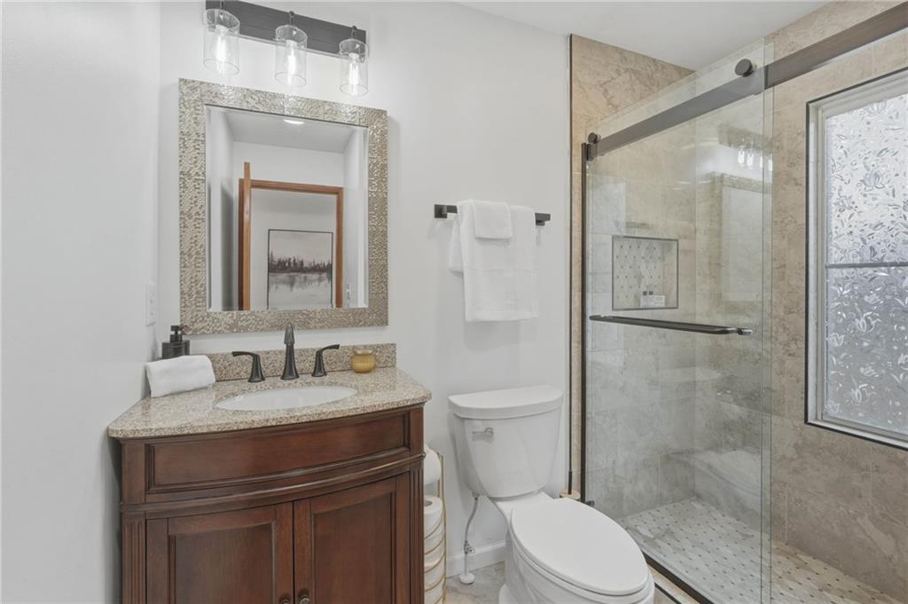 3812 James Ed Road Gainesville, GA 30506 - Photo 11 of 27 a bathroom with a sink vanity mirror and toilet
