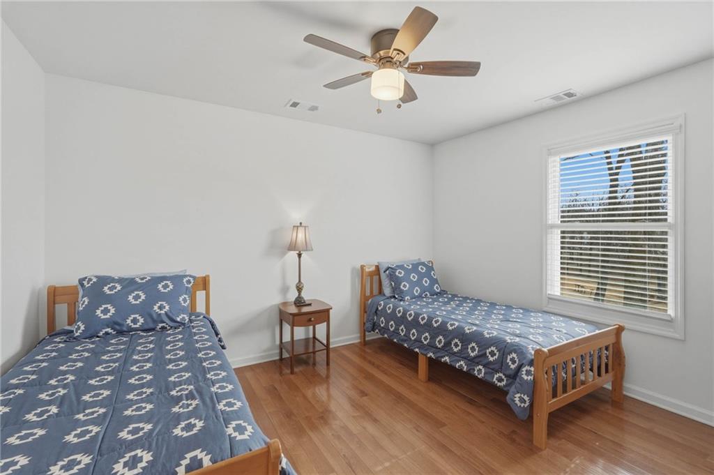 3812 James Ed Road Gainesville, GA 30506 - Photo 15 of 27 a bedroom with a bed and a chandelier