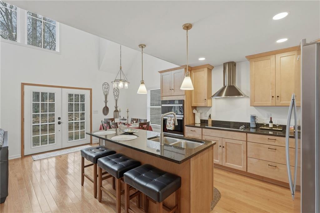 3812 James Ed Road Gainesville, GA 30506 - Photo 3 of 27 a kitchen with a stove a sink a dining table and chairs