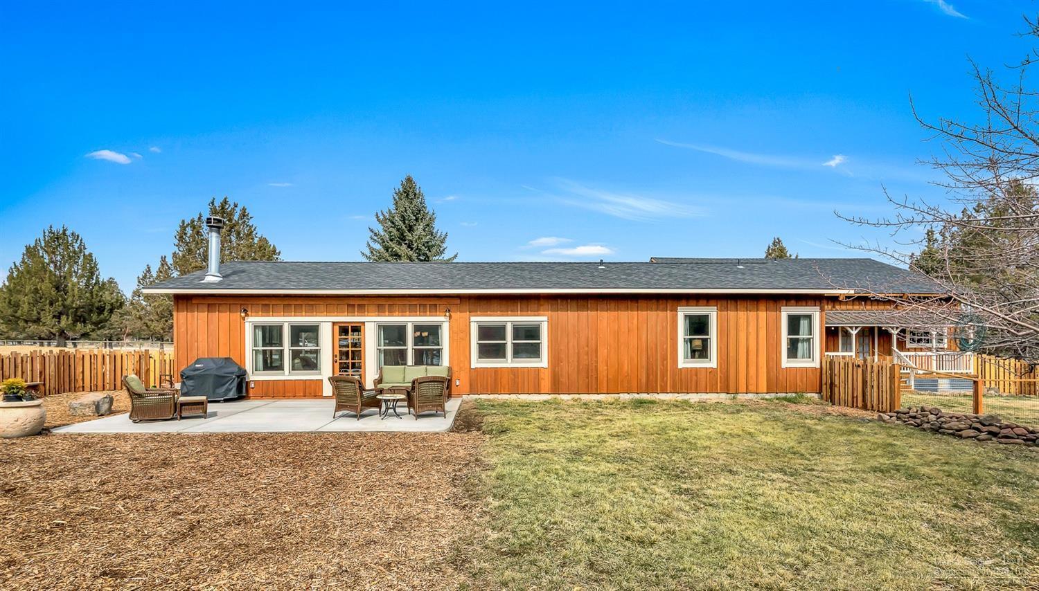 18360 Pinehurst Road Bend, OR 97703 - Photo 20 of 25 a front view of a house with a yard and garage