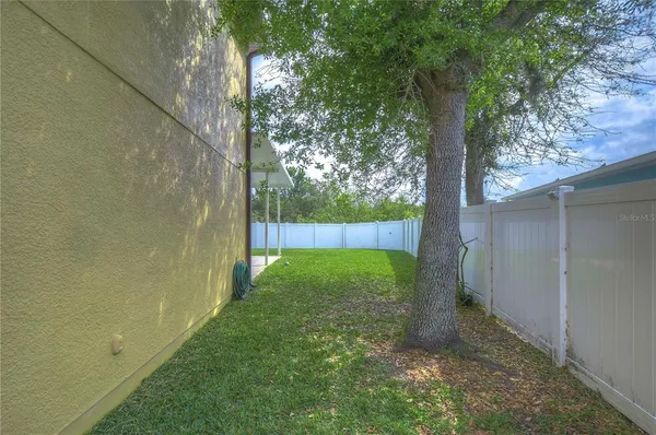 a view of a chair and table in backyard of the house
