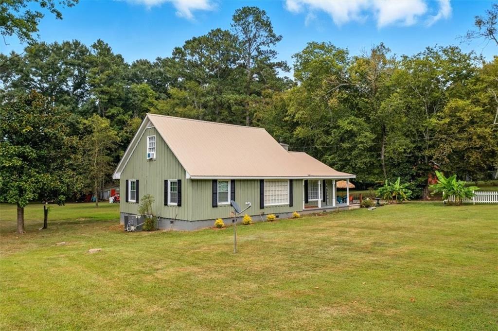 a front view of a house with a garden and trees