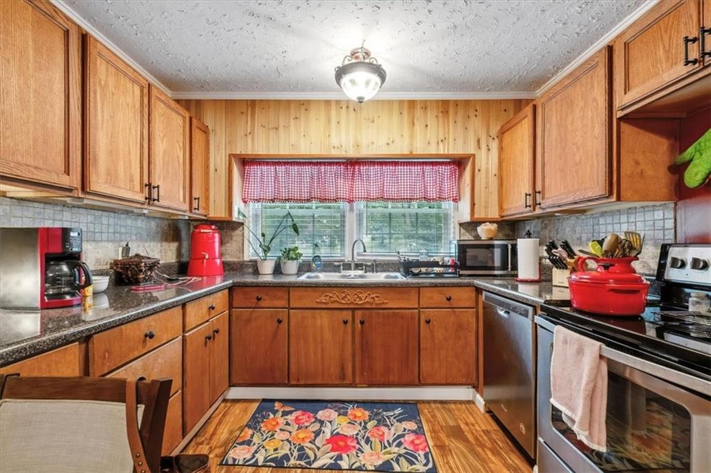 241 River Bend Road Southwest Plainville, GA 30733 - Photo 11 of 27 a kitchen with stainless steel appliances a stove top oven
