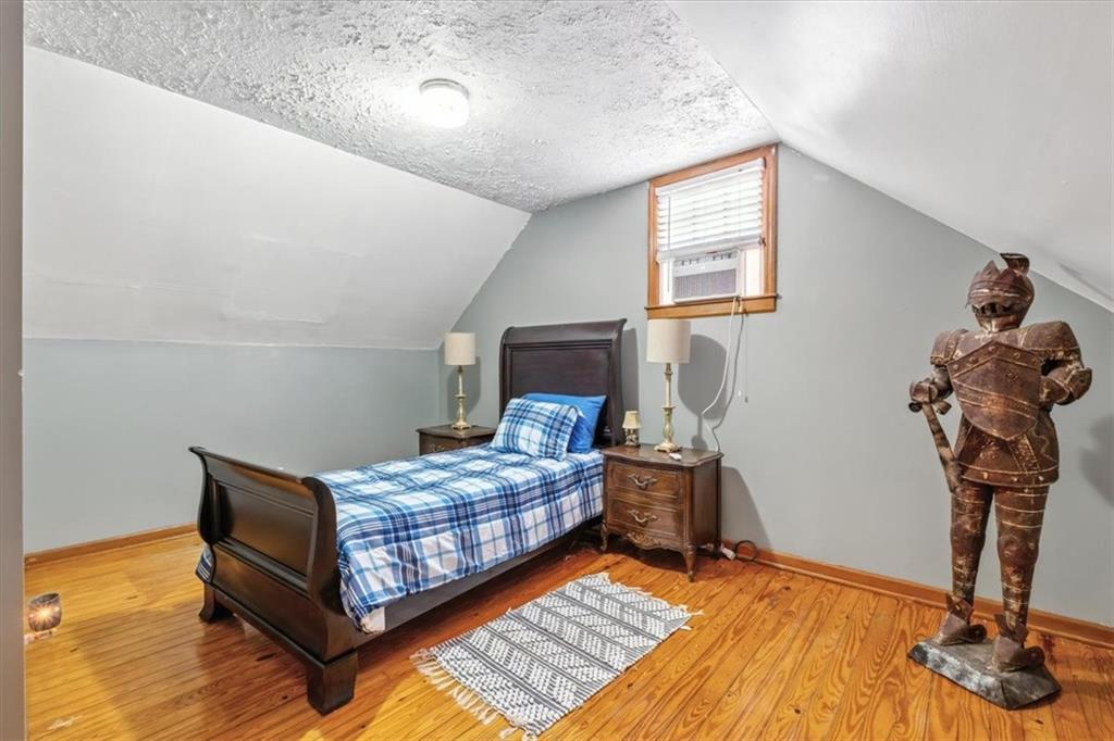 241 River Bend Road Southwest Plainville, GA 30733 - Photo 17 of 27 a bedroom with a bed and wooden floor