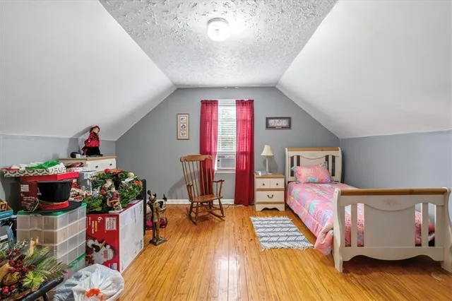 a bedroom with furniture and a wooden floor