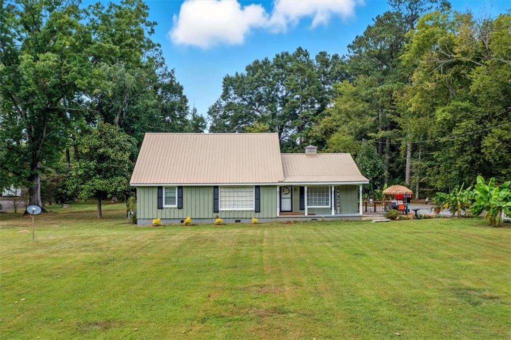 241 River Bend Road Southwest Plainville, GA 30733 - Photo 2 of 27 a front view of a house with a garden and trees