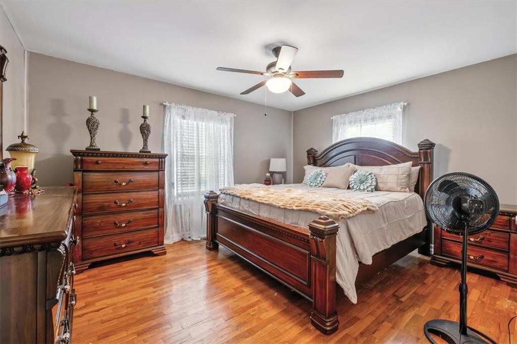 241 River Bend Road Southwest Plainville, GA 30733 - Photo 21 of 27 a bedroom with a bed and a chandelier