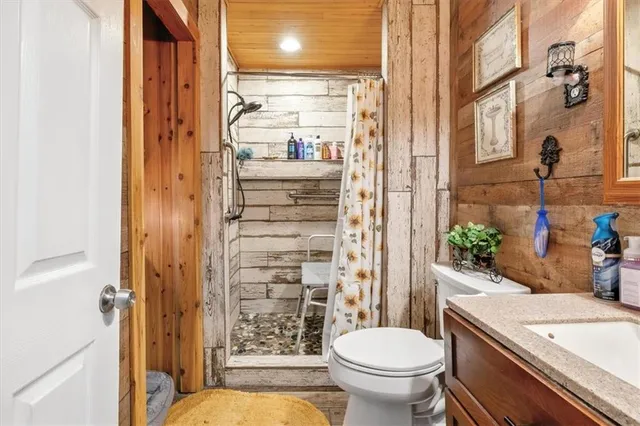 a bathroom with a sink a toilet and shower curtain