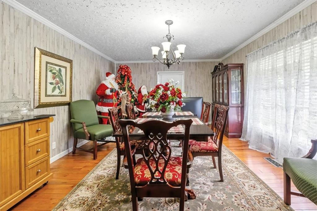 241 River Bend Road Southwest Plainville, GA 30733 - Photo 26 of 27 a view of a dining room with furniture a chandelier and wooden floor