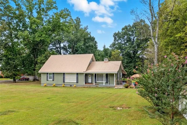 a front view of a house with a garden