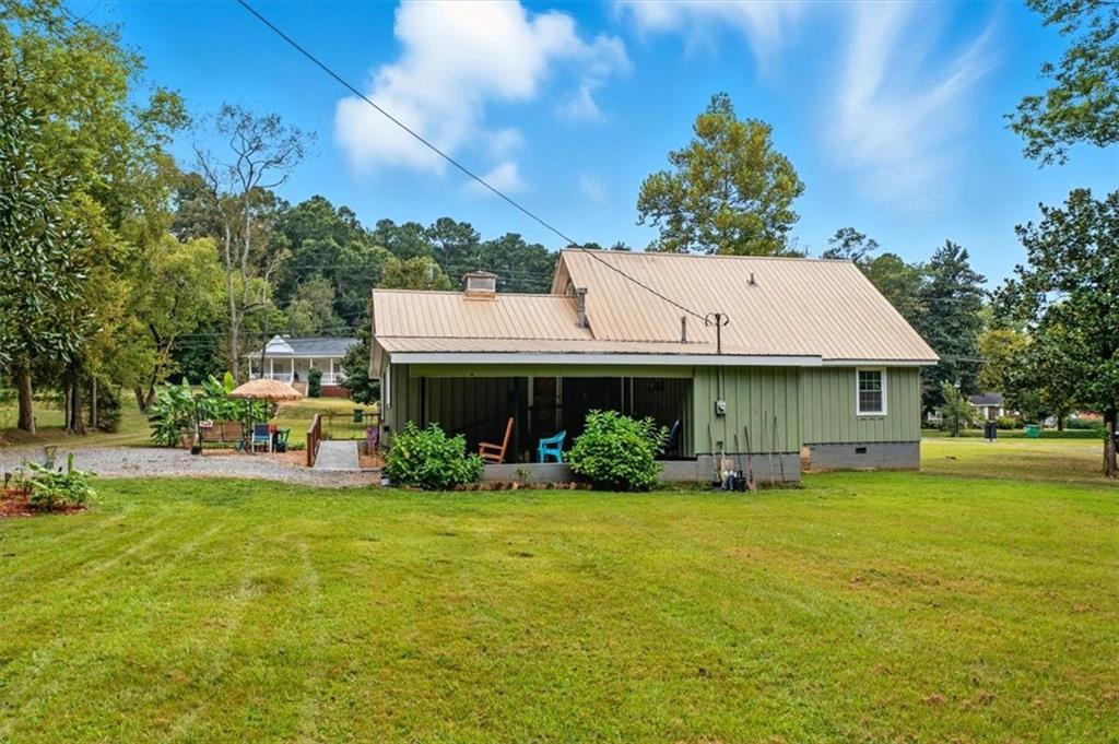 241 River Bend Road Southwest Plainville, GA 30733 - Photo 5 of 27 a view of a house with a garden and pathway