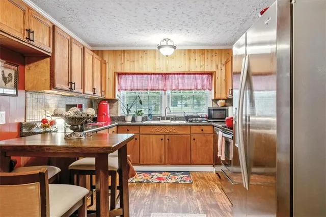 a kitchen with a refrigerator and a window