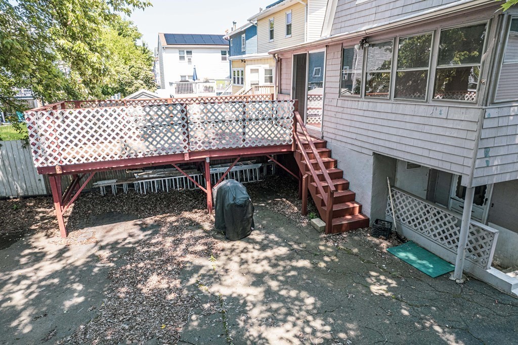 51 Bay Road Revere, MA 02151 - Photo 27 of 34 a view of a patio with table and chairs with wooden fence and plants