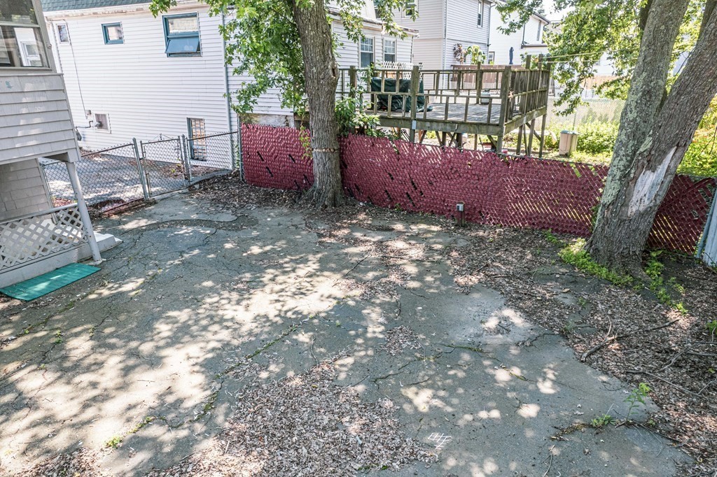 51 Bay Road Revere, MA 02151 - Photo 28 of 34 a view of a yard with plants and a bench