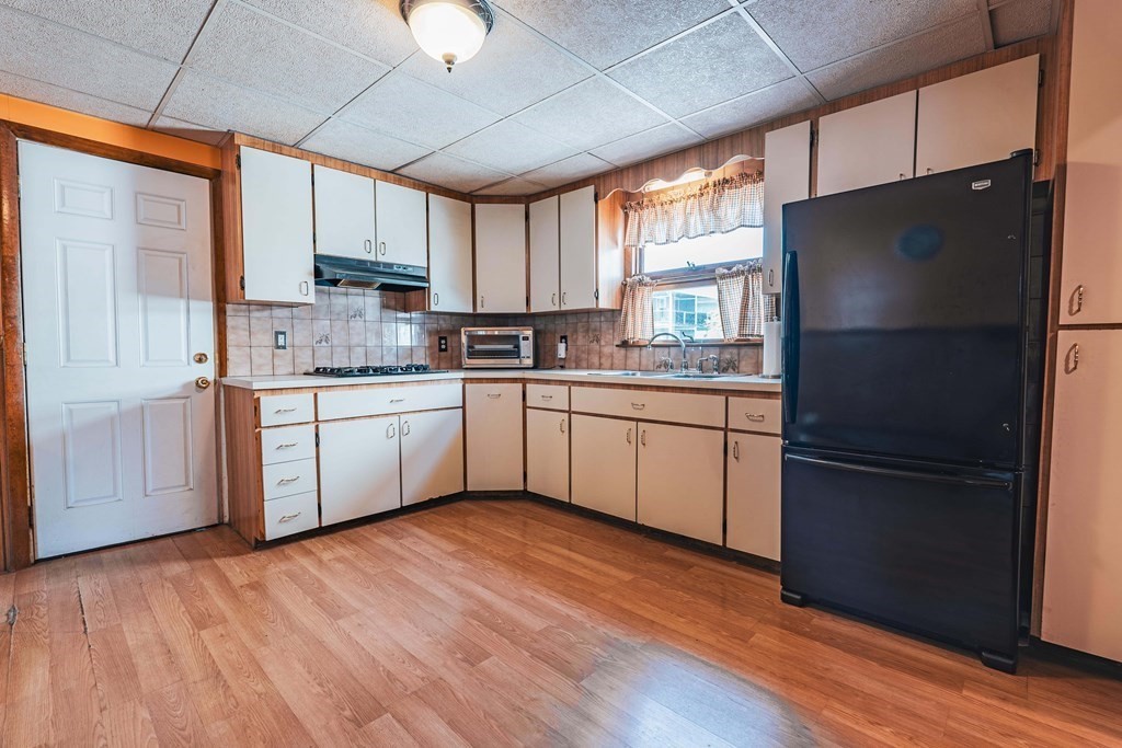 51 Bay Road Revere, MA 02151 - Photo 8 of 34 a kitchen with a sink a refrigerator and window
