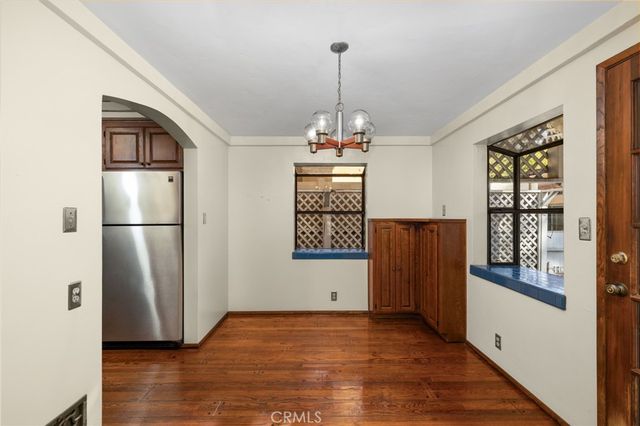 a view of a refrigerator in kitchen and wooden floor