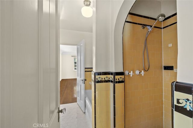a bathroom with a shower and a mirror