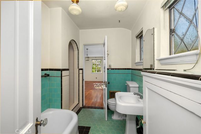 a bathroom with a sink a toilet and tub