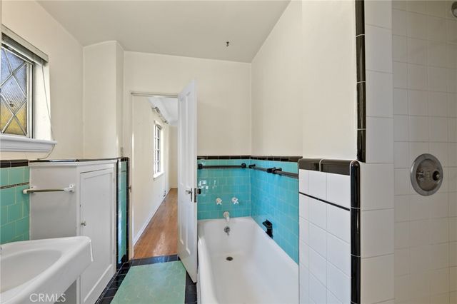 a bathroom with a bathtub and a shower