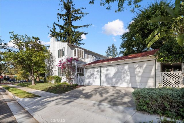 a front view of a house with a yard and a garage