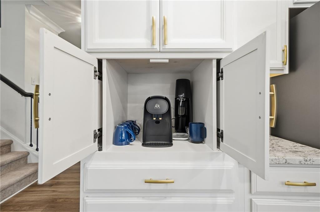 707 Evergreen Lane Canton, GA 30114 - Photo 15 of 59 a kitchen with a refrigerator and a wooden floor