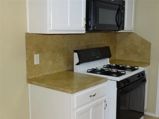 a kitchen with a stove and a microwave