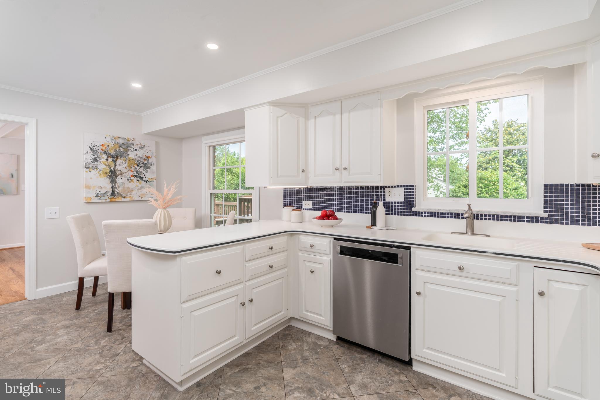 8712 Fox Run Potomac, MD 20854 - Photo 20 of 49 a kitchen with white cabinets and window