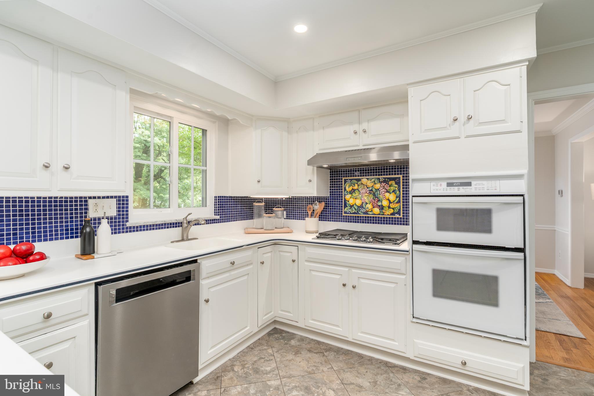 8712 Fox Run Potomac, MD 20854 - Photo 21 of 49 a kitchen with white cabinets appliances and a window