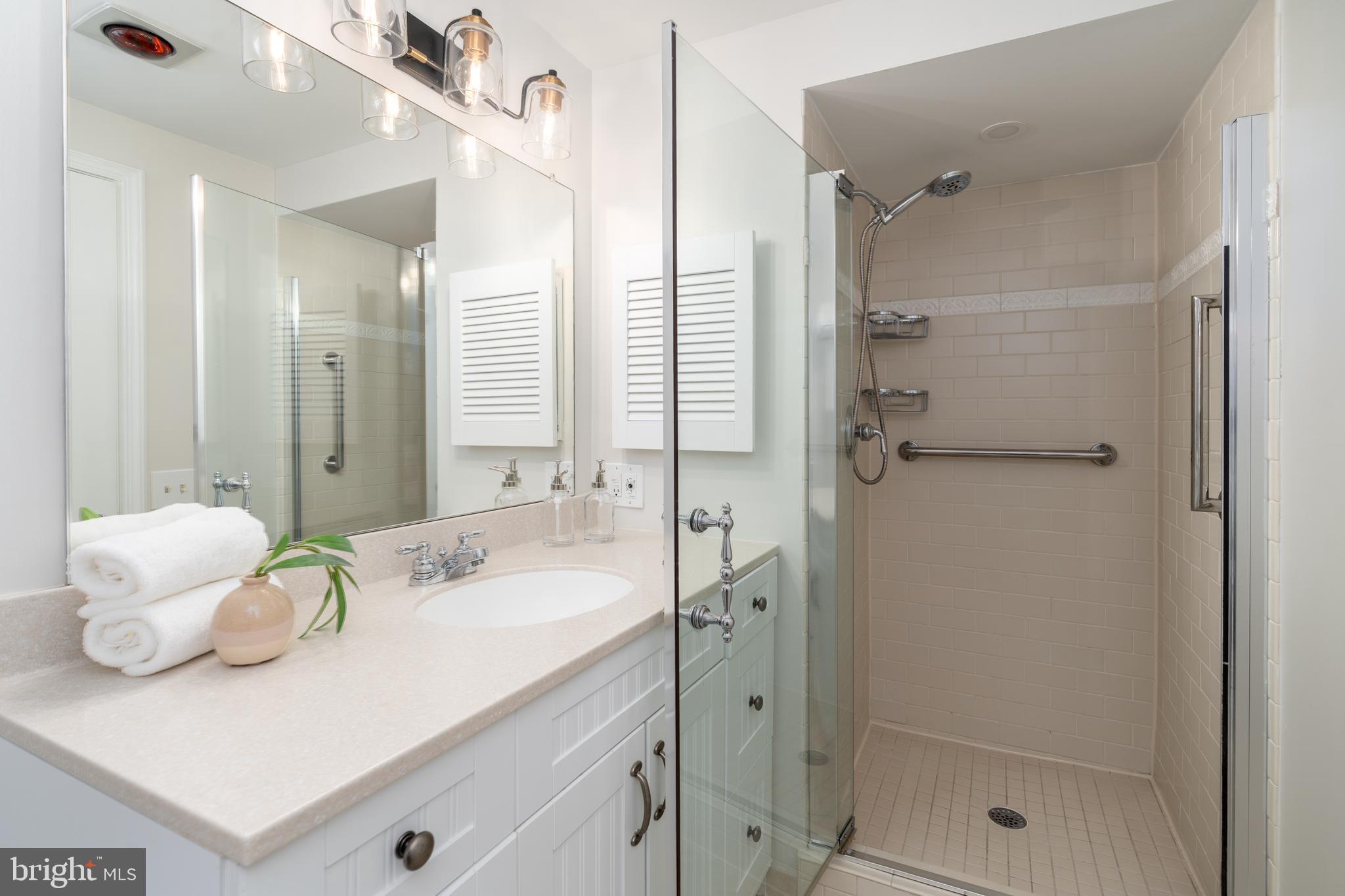8712 Fox Run Potomac, MD 20854 - Photo 25 of 49 a bathroom with a double vanity sink mirror and shower
