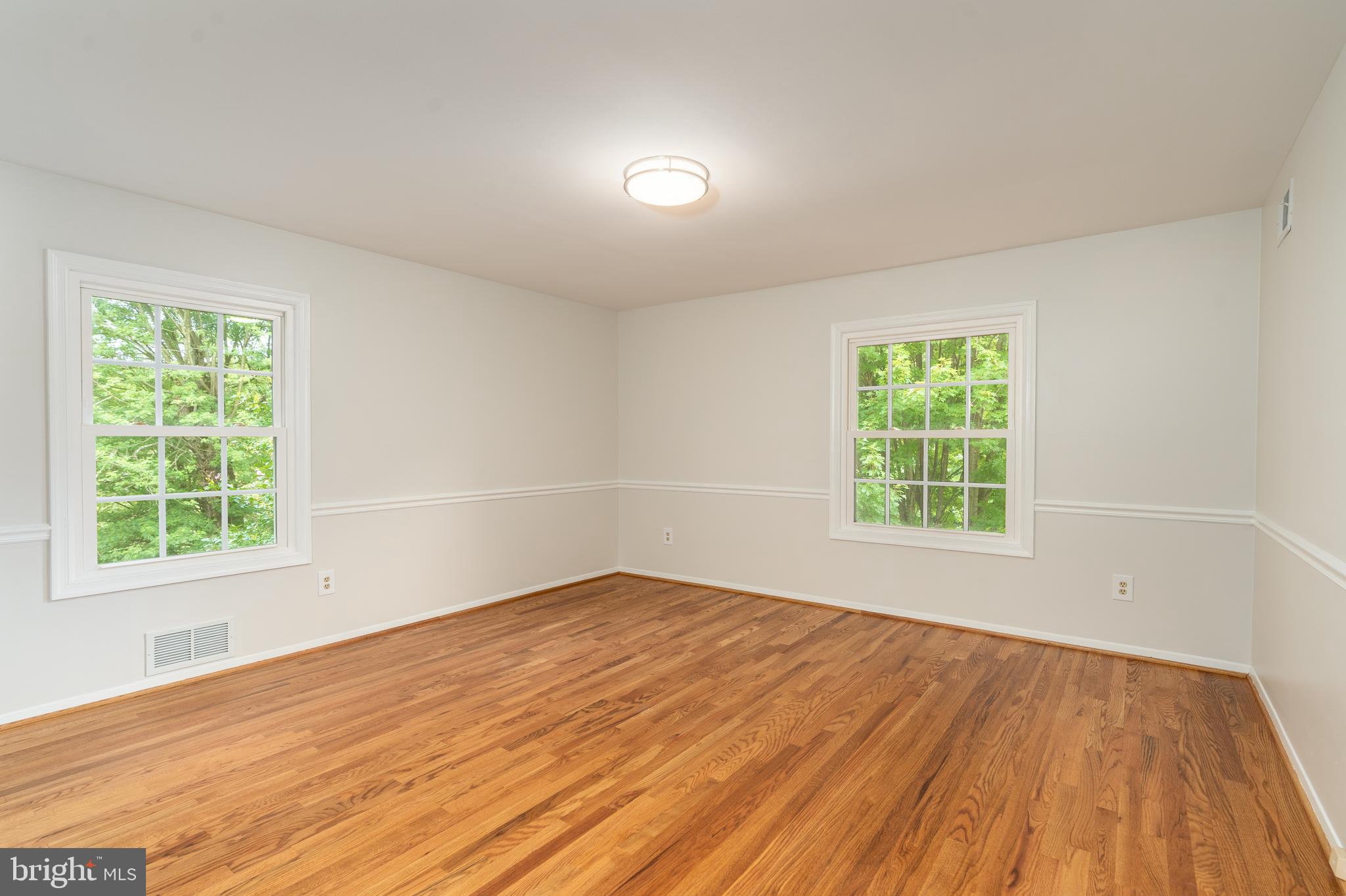 8712 Fox Run Potomac, MD 20854 - Photo 27 of 49 an empty room with wooden floor and windows