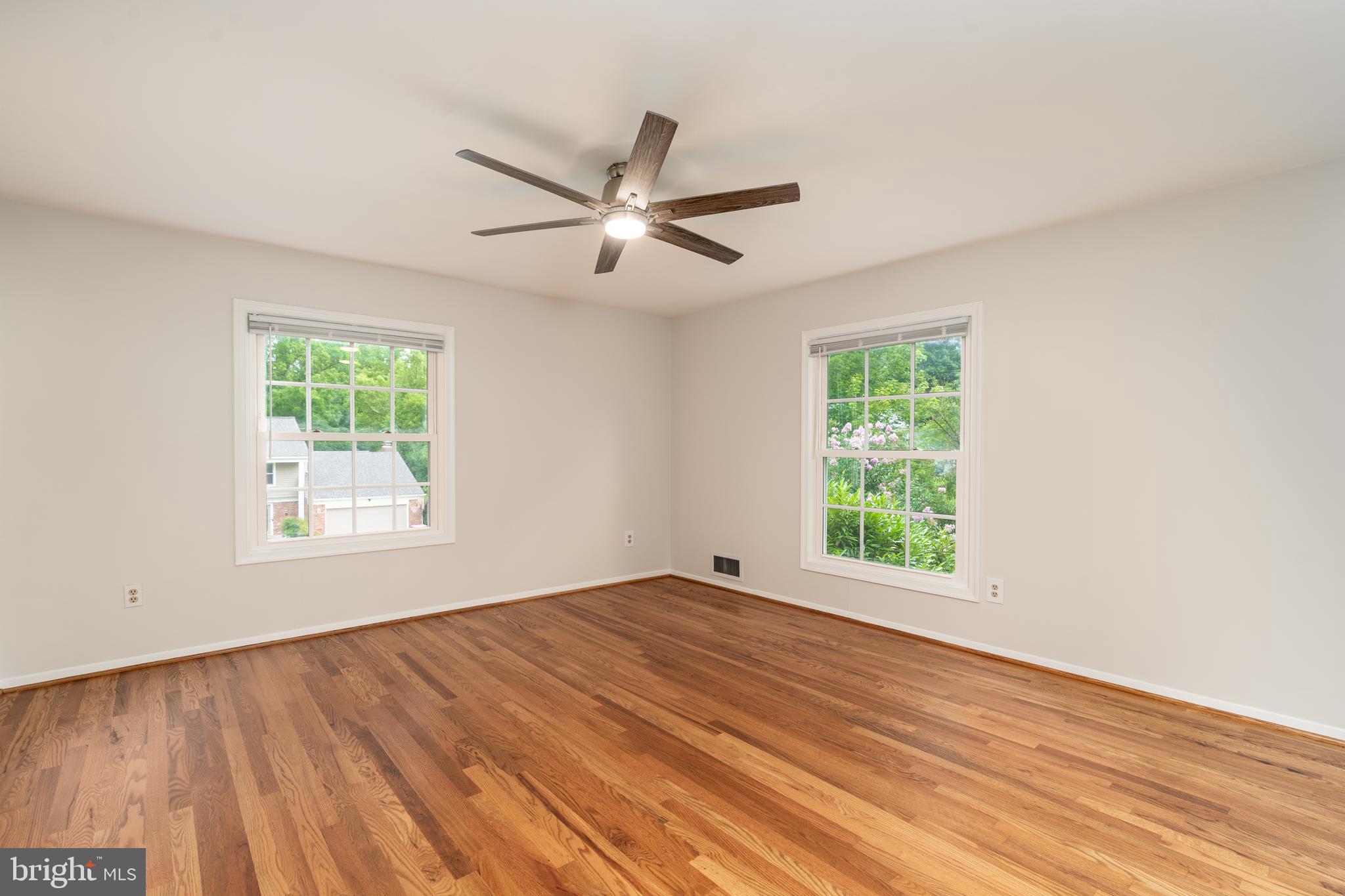 8712 Fox Run Potomac, MD 20854 - Photo 28 of 49 a view of an empty room with wooden floor and a window