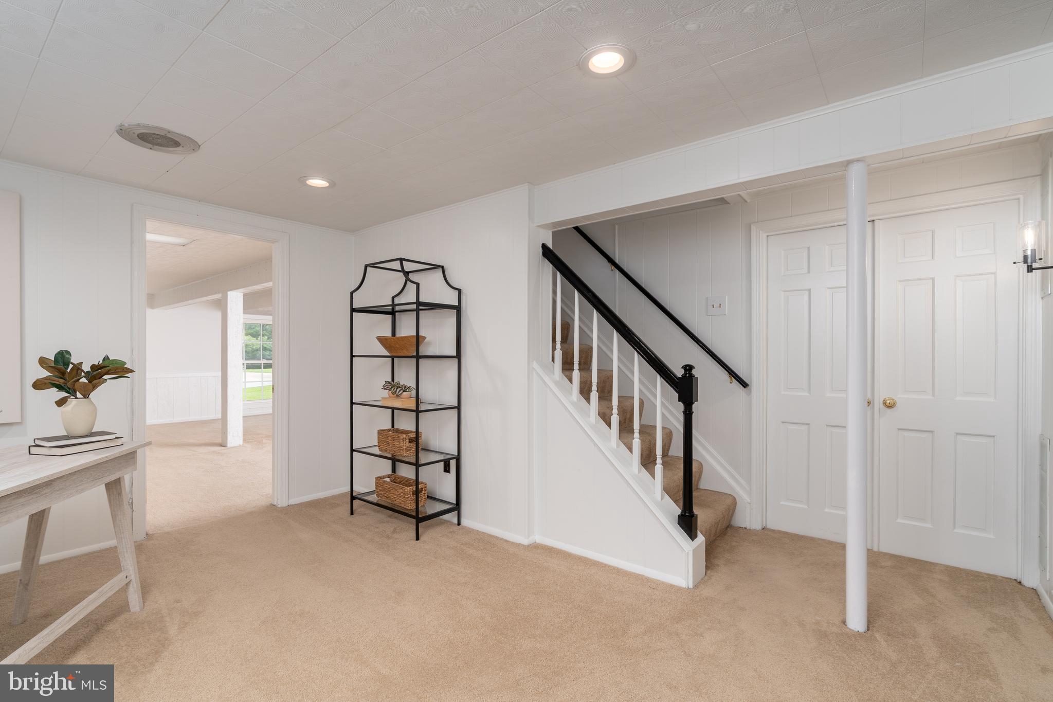 8712 Fox Run Potomac, MD 20854 - Photo 31 of 49 a view of an empty room with staircase and white walls