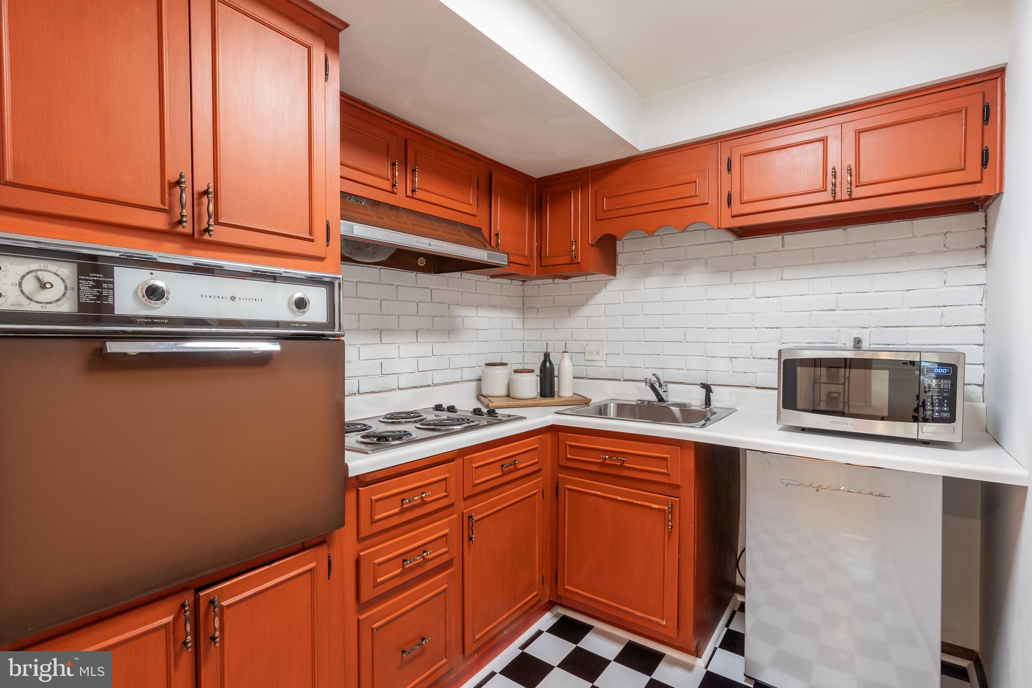8712 Fox Run Potomac, MD 20854 - Photo 33 of 49 a kitchen with stainless steel appliances granite countertop a sink stove and cabinets