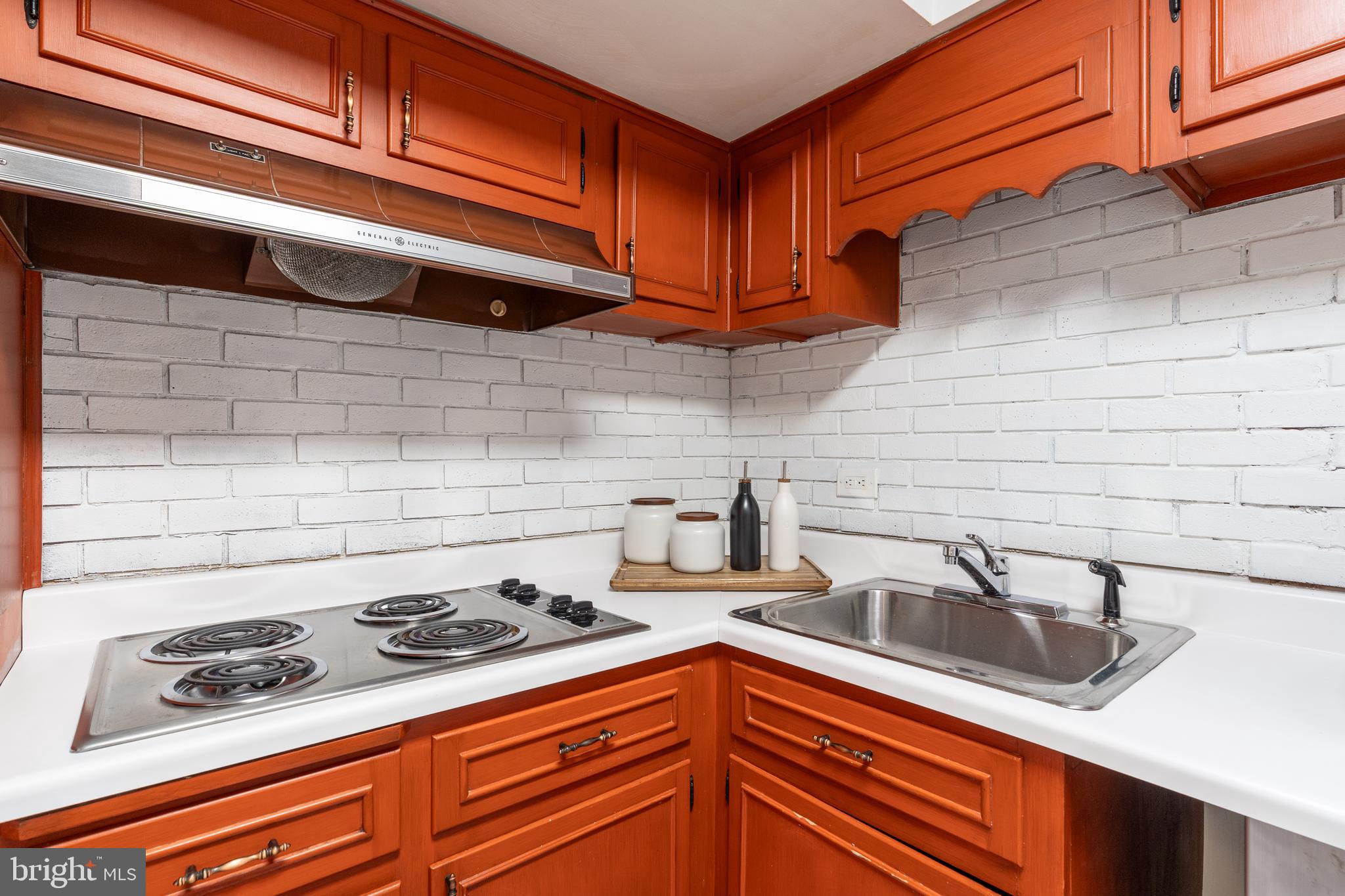 8712 Fox Run Potomac, MD 20854 - Photo 34 of 49 a kitchen with stainless steel appliances granite countertop a sink stove and cabinets