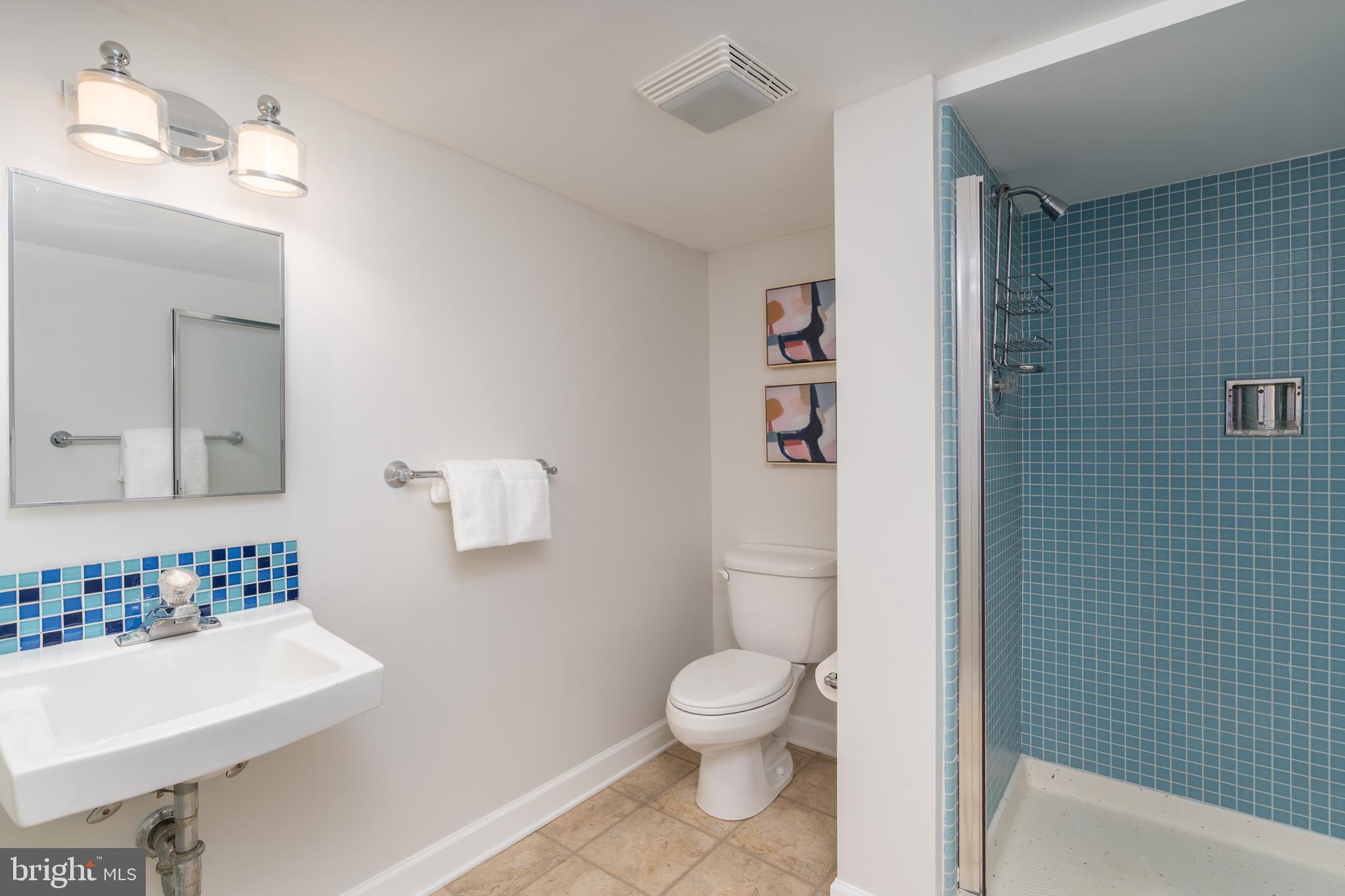 8712 Fox Run Potomac, MD 20854 - Photo 37 of 49 a white toilet sitting next to a bathroom sink