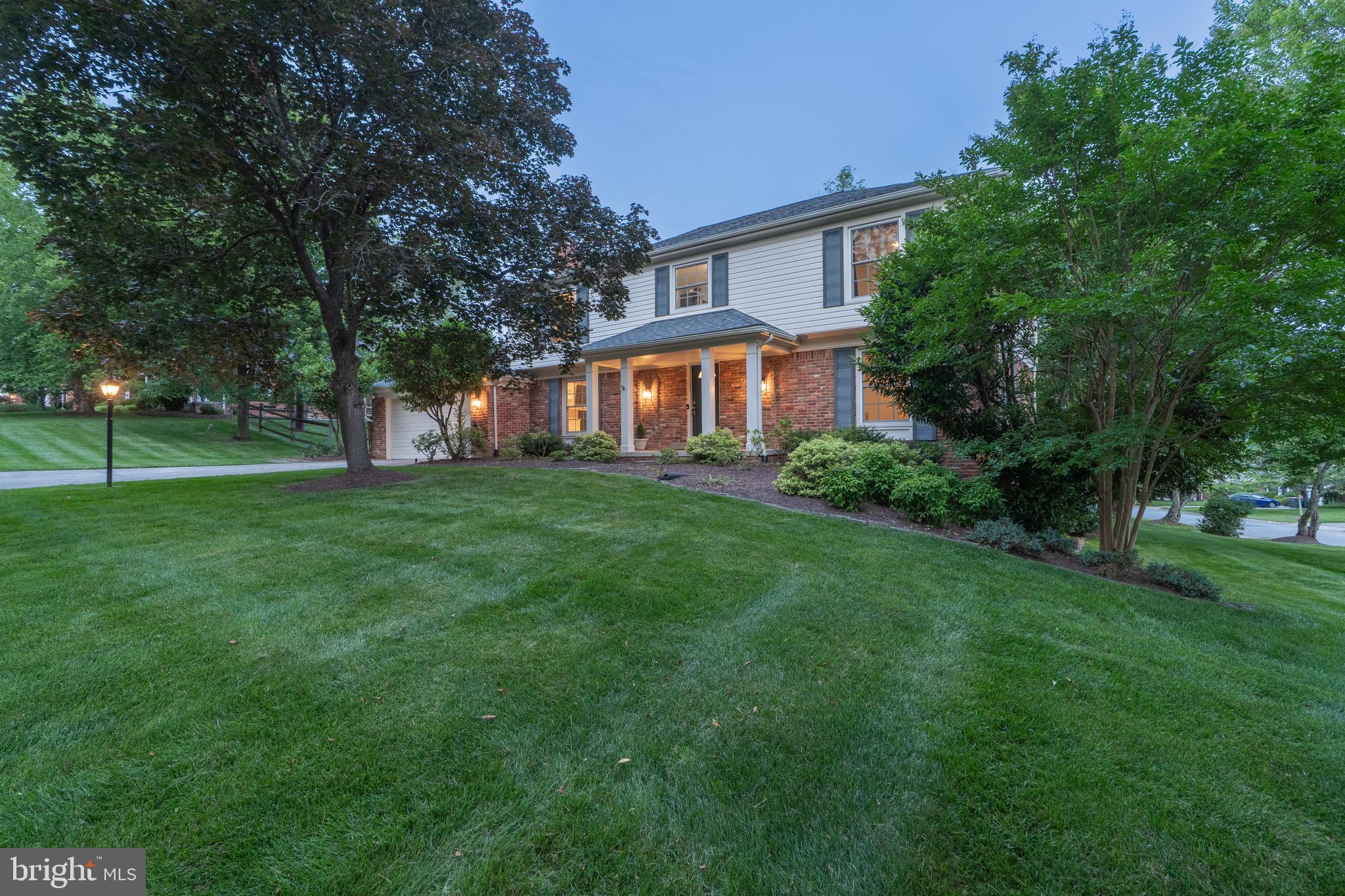 8712 Fox Run Potomac, MD 20854 - Photo 4 of 49 a view of a house next to a big yard and large trees