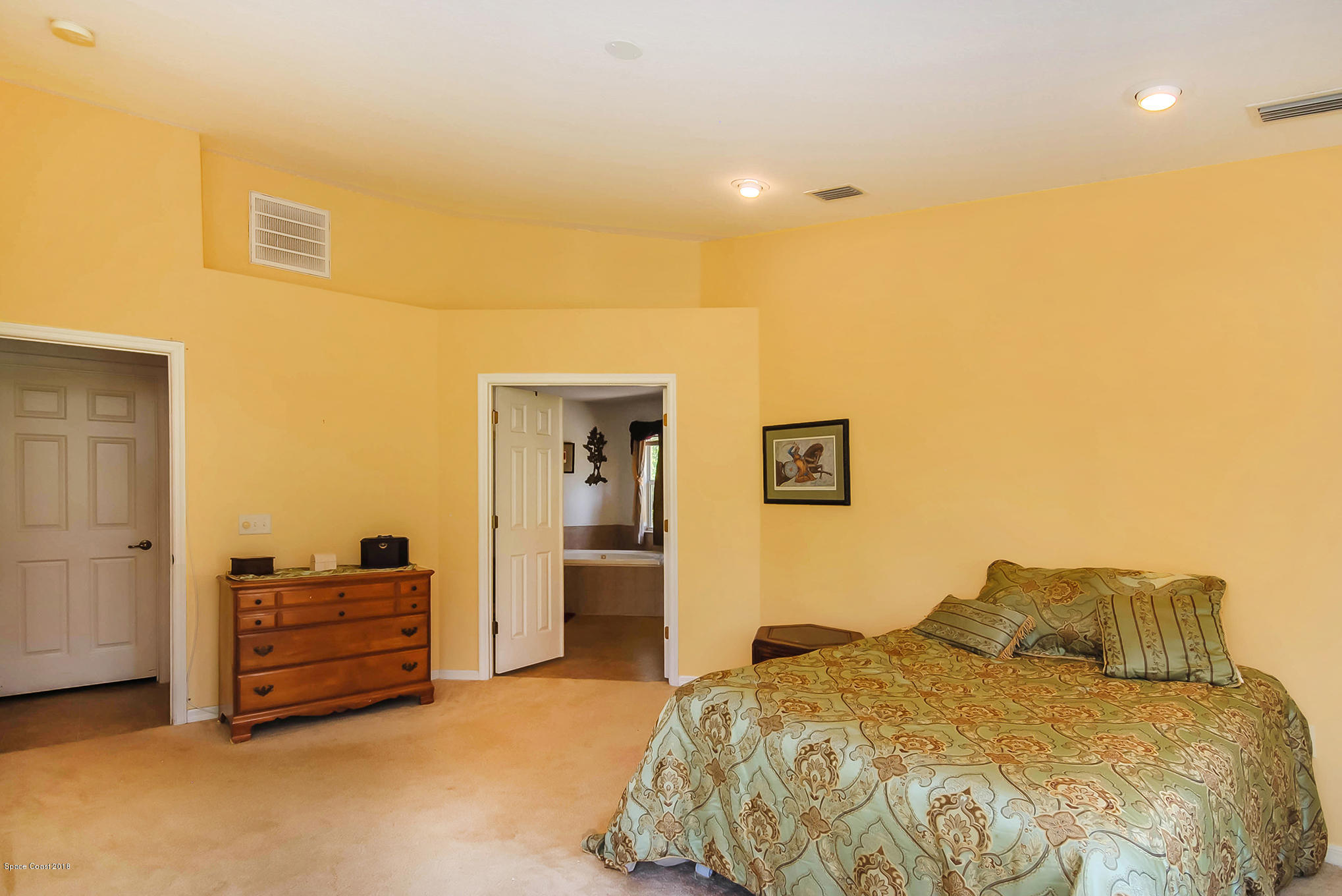 1317 Degroodt Road Southwest Palm Bay, FL 32908 - Photo 15 of 26 a bedroom with a bed and a cabinets