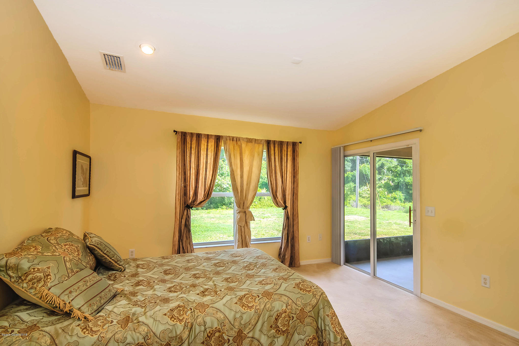 1317 Degroodt Road Southwest Palm Bay, FL 32908 - Photo 16 of 26 a bedroom with a bed and a window