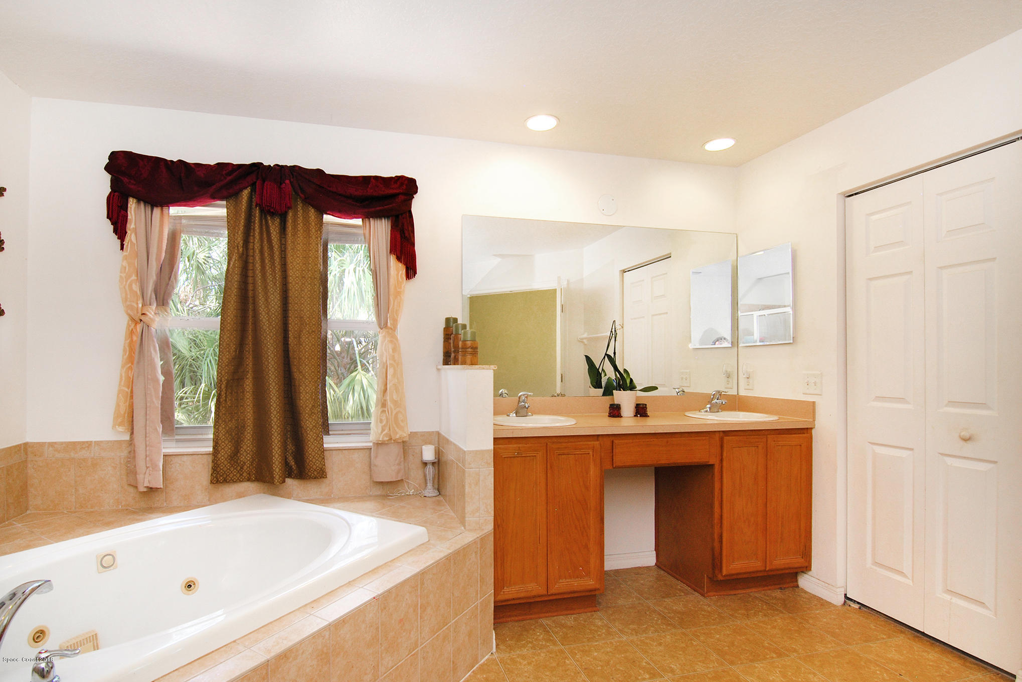 1317 Degroodt Road Southwest Palm Bay, FL 32908 - Photo 17 of 26 a bathroom with a tub sink and mirror