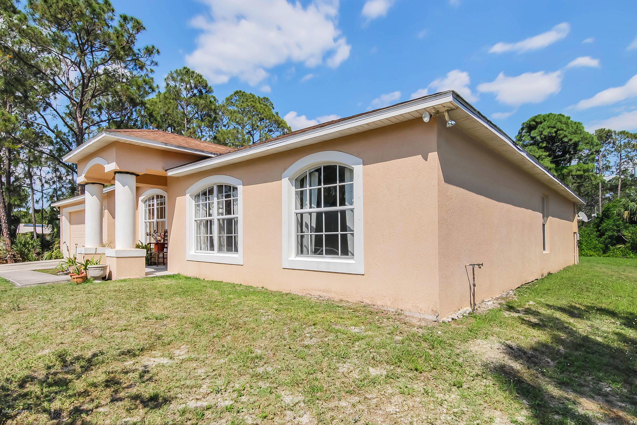 1317 Degroodt Road Southwest Palm Bay, FL 32908 - Photo 3 of 26 a front view of a house with a yard