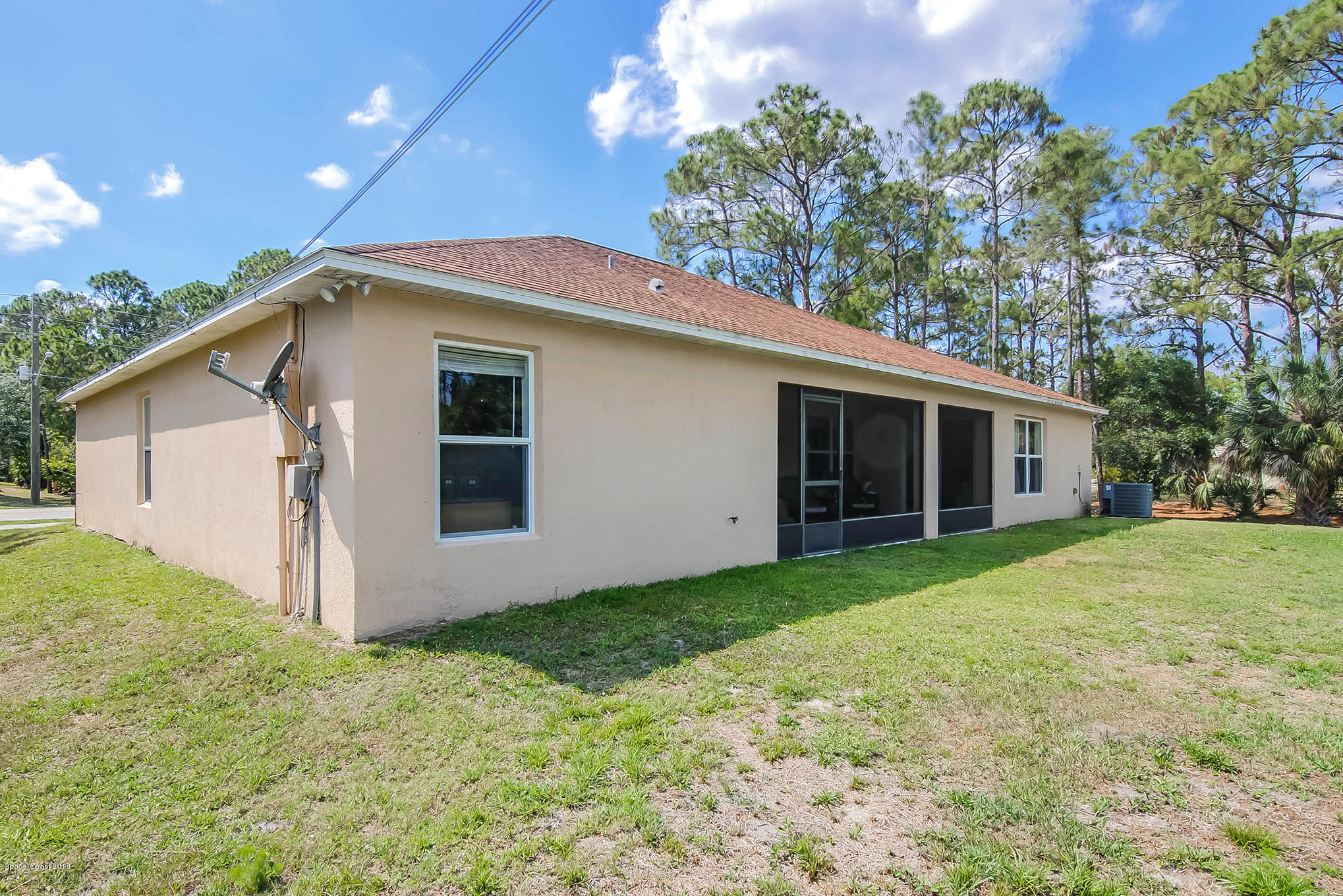 1317 Degroodt Road Southwest Palm Bay, FL 32908 - Photo 25 of 26 a view of a house with a yard