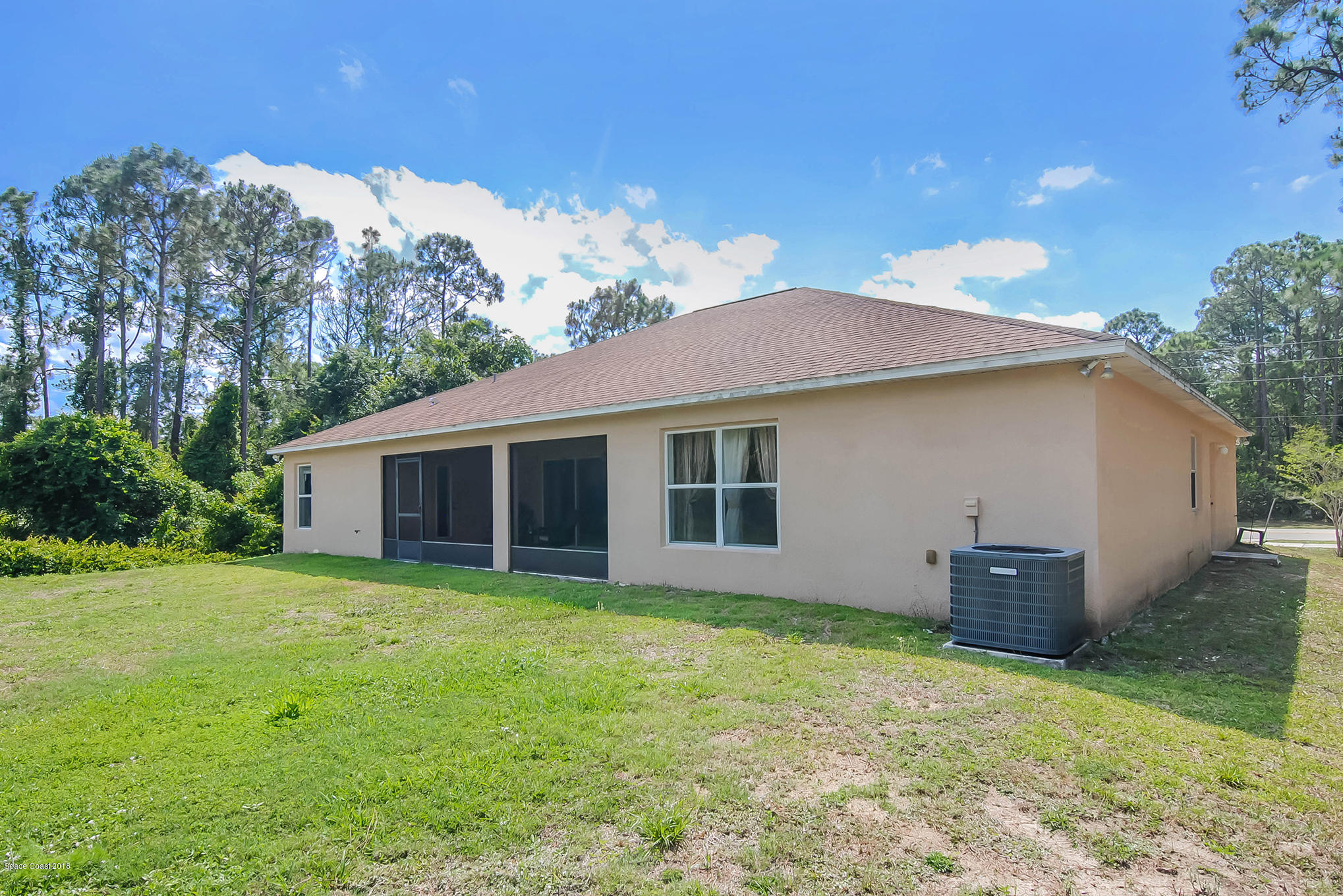 1317 Degroodt Road Southwest Palm Bay, FL 32908 - Photo 26 of 26 a backyard of a house with oven and garden