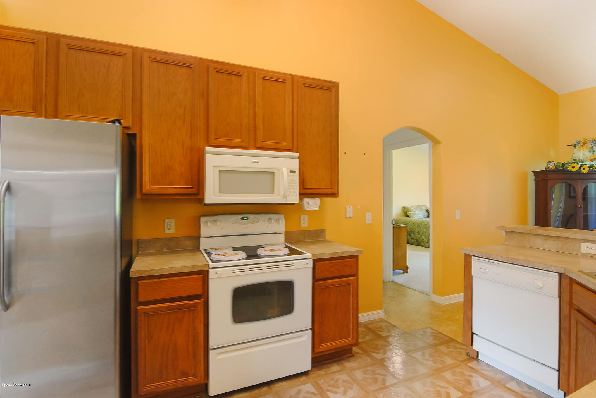 1317 Degroodt Road Southwest Palm Bay, FL 32908 - Photo 10 of 26 a kitchen with a stove top oven and cabinets