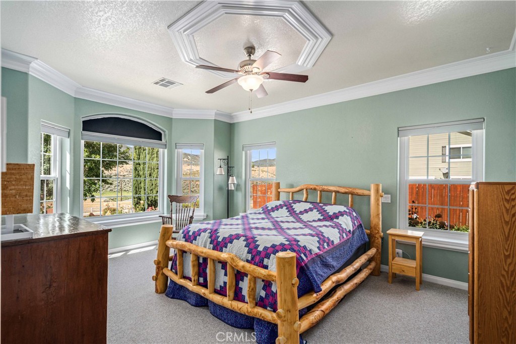9251 Elizabeth Lake Road Leona Valley, CA 93551 - Photo 21 of 53 a bedroom with a bed table and window